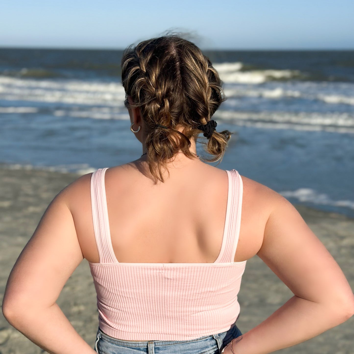 ocean with girl wearing a pink ribbed tank top 